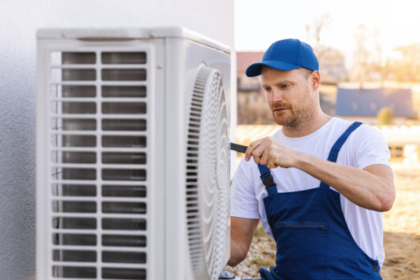 HVAC technician testing refrigerant lines and airflow during precise residential air conditioning installation