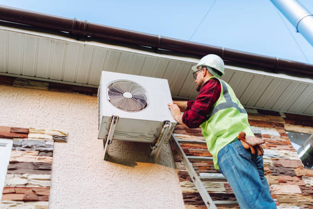 Crew installing new central air system in occupied Mineola split-level home