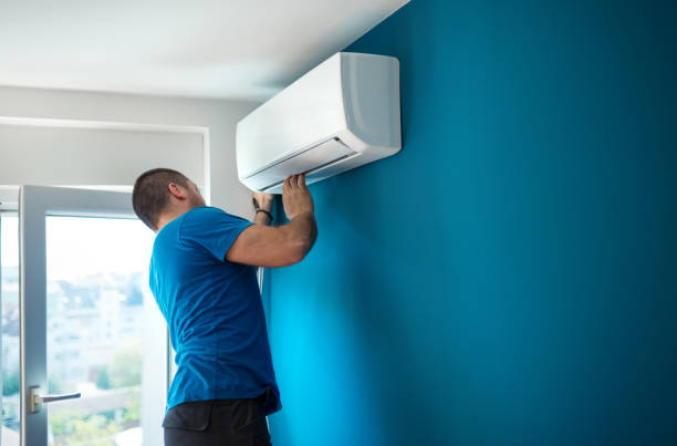 HVAC installer testing airflow balance and thermostat response after system setup
