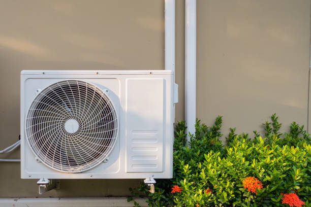 Technician inspecting clogged AC filter and airflow issues in Huntington family home