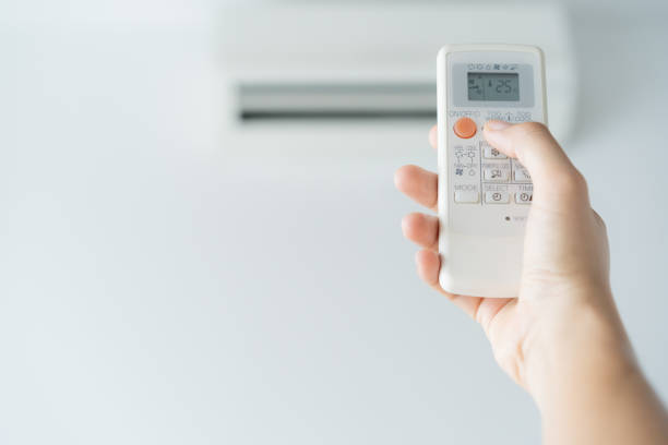 Experienced HVAC technician testing coastal AC system components with diagnostic tools