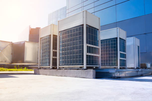 Experienced HVAC professional measuring airflow and checking system performance indoors