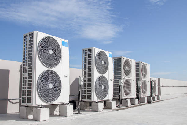 Skilled HVAC professional inspecting air handler connections and testing system performance