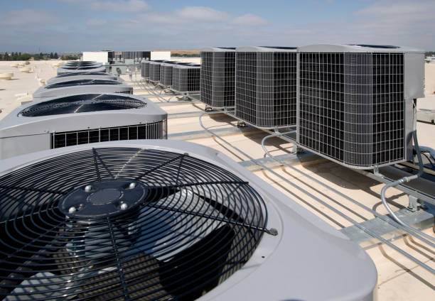 Skilled technician measuring HVAC output and inspecting system components in utility area