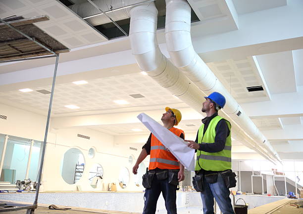 Experienced HVAC professional testing airflow and thermostat response with diagnostic tools