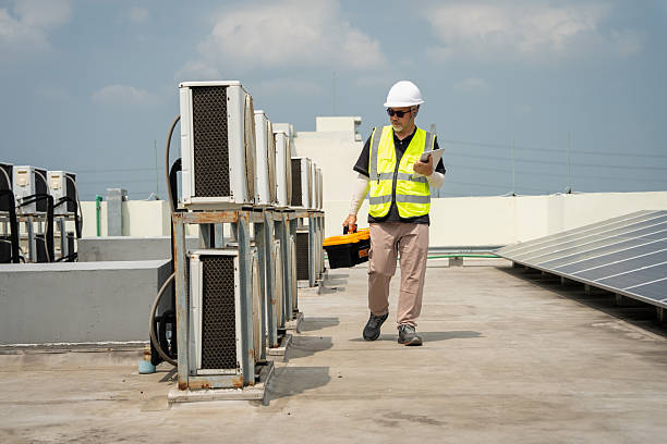 Skilled HVAC technician testing system performance with gauges and airflow tools