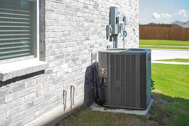 HVAC professional inspecting duct connections and testing equipment performance with precision tools