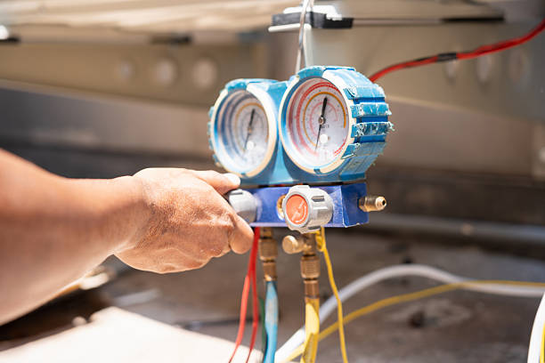 Technician servicing residential HVAC equipment in a Long Beach utility area, Commercial HVAC specialist testing control panels inside a Hempstead - NY office mechanical room