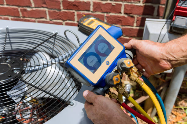Experienced technician inspecting HVAC components and testing airflow performance carefully
